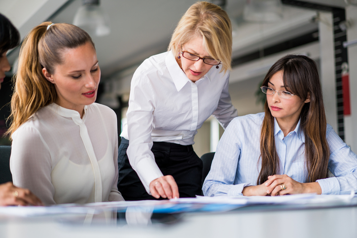 Manager explaining strategy to executives at desk